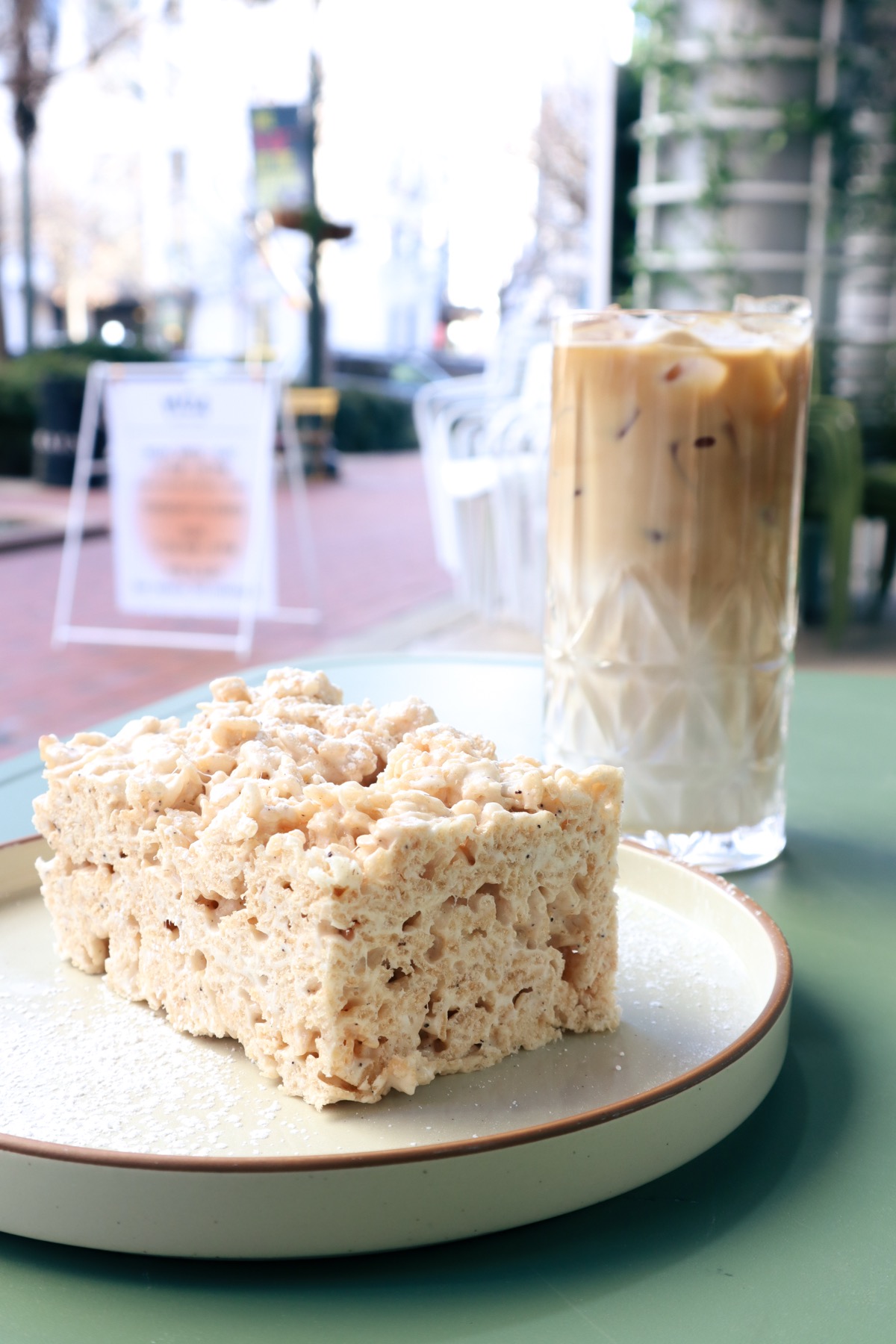 Brown butter rice crispy dessert cut into squares in a pastry case.