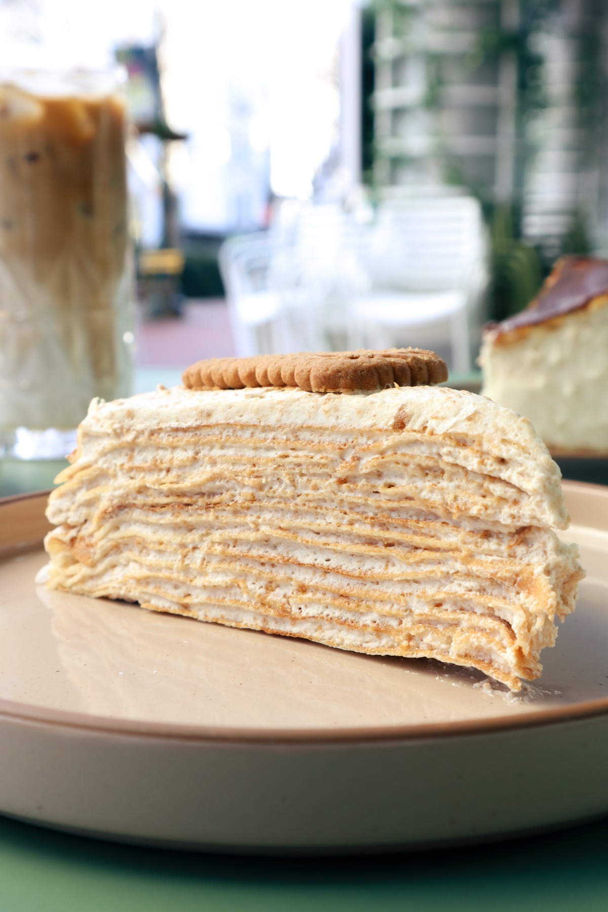 Layered crepe cake slice with cream between thin crepe layers.